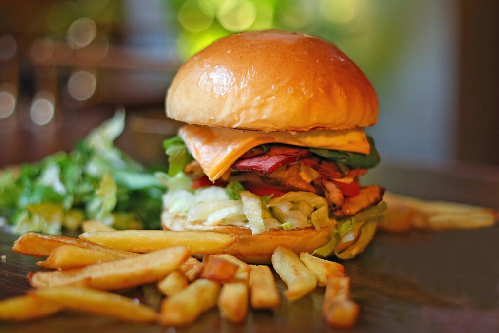 Delicious cheeseburger with lettuce and fries, perfect for food lovers.