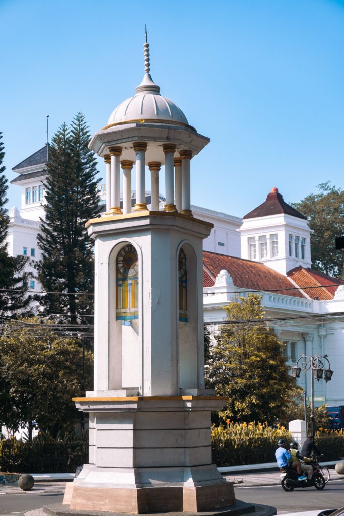 Street view of a historical monument in Bandung, Indonesia, showcasing colonial architecture.